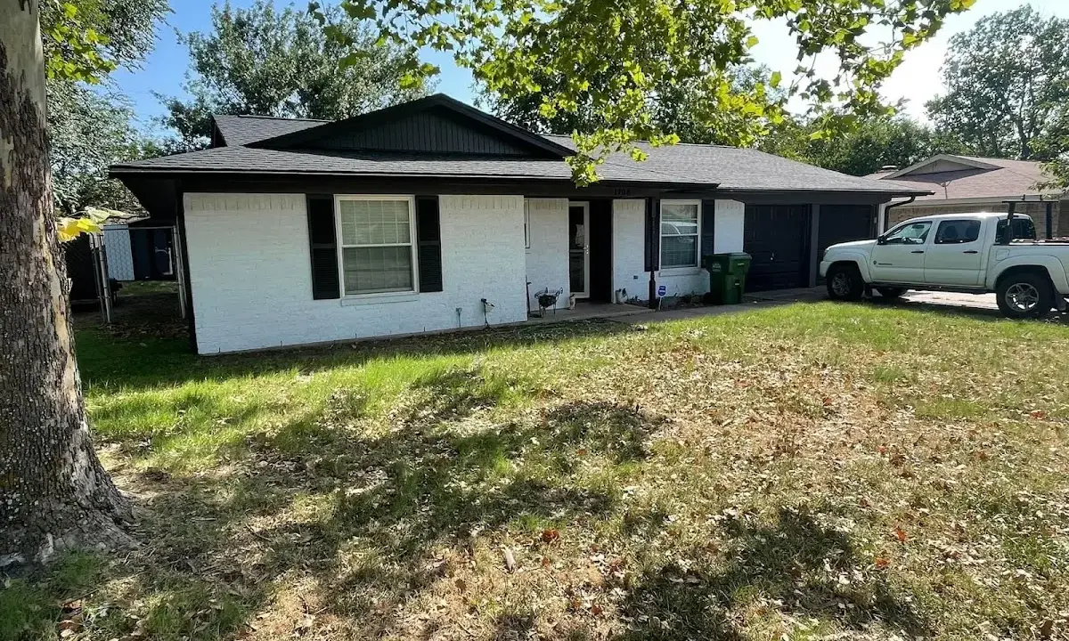 Professional roofing crew working on a residential roof in Holly Ridge